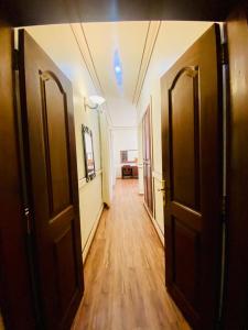 an empty hallway with two doors and a room with a table at Haylo Hotel in Kampala