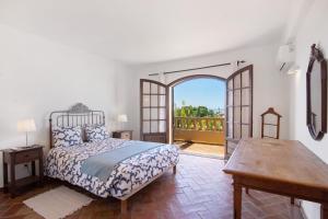 a bedroom with a bed and an open door at Villa Rústica in Albufeira +37 photos