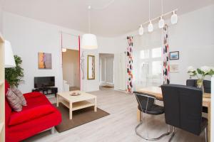 uma sala de estar com um sofá vermelho e uma mesa em Apartment Uthman Berlin-Neukölln em Berlim