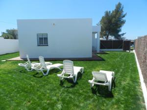 a group of lawn chairs sitting on the grass at DADA CAÑOS in Los Caños de Meca