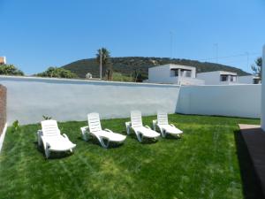 a group of lawn chairs sitting on the grass at DADA CAÑOS in Los Caños de Meca