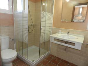 a bathroom with a shower and a toilet and a sink at DADA CAÑOS in Los Caños de Meca