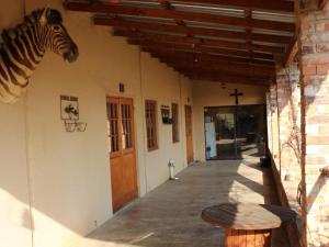 a zebra head on the side of a building at Mosamane Guest Farm in Rosendal
