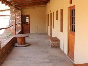 an empty room with a bench and a table at Mosamane Guest Farm in Rosendal