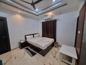 a room with a bed and a ceiling at Alohi Homestay Near Rahman Hospitals Pvt Ltd in Guwahati