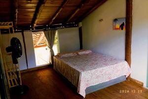 Ένα ή περισσότερα κρεβάτια σε δωμάτιο στο Casa Amarela Conchegante