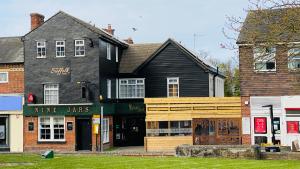 a black building with a store in front of it at The Suffolk Hotel in Haverhill