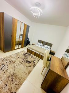 a bedroom with a bed and a table and a chair at 2BD prime apartment in rehab city in New cairo