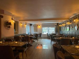 a restaurant with tables and chairs in a room at The Suffolk Hotel in Haverhill