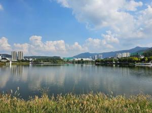a large body of water with buildings in the background at PATIO Stay in Daegu