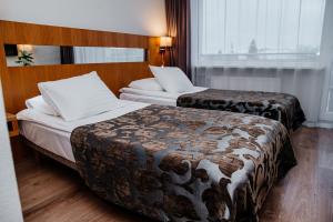 Postel nebo postele na pokoji v ubytování Pärnu Hotel + 37 fotografií