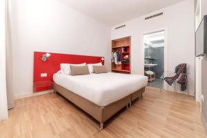 a bedroom with a large bed with a red headboard at Hotel Piazza Bellini & Apartments in Naples