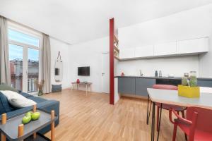a living room with a blue couch and a table at Hotel Piazza Bellini & Apartments in Naples