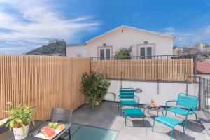 a patio with chairs and tables and a fence at Hotel Piazza Bellini & Apartments in Naples