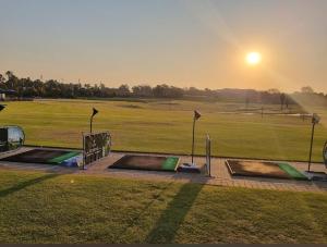 a view of a golf course with the sunset in the background at Charming Hideaway in Sandton