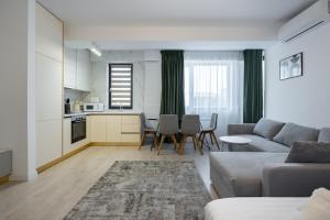 una sala de estar con un sofá y una mesa en Residence 5 Studio, en Voluntari