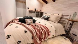 a bedroom with a bed with a blanket on it at Cozy Alpine Attic in Savièse