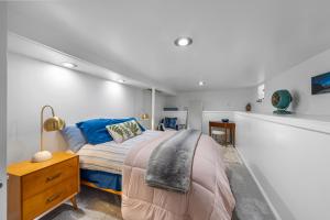 a bedroom with a bed and a desk and a lamp at Urban Escape by Mountains w/3BR, Wi-Fi, Laundry in Salt Lake City