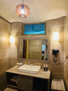 a bathroom with a sink and a mirror at Mara Sweet Acacia Lodge in Talek