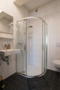 a bathroom with a glass shower and a sink at Luttik Oudorp 30 in Alkmaar +43 photos