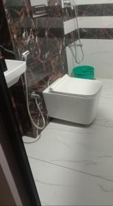 a bathroom with a white toilet and a sink at Marari Beach Daze homestay in Alleppey