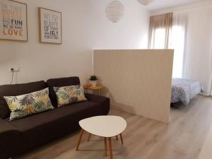 a living room with a couch and a table at LovelyLoft Pablo Old Town in Alicante