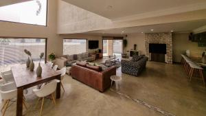 a large living room with a couch and a table at Vogelstrand Holiday House in Swakopmund