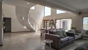 a living room with a couch and a table at Vogelstrand Holiday House in Swakopmund