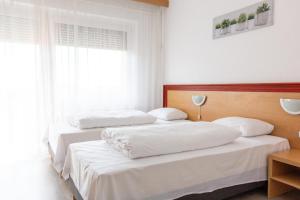 Postel nebo postele na pokoji v ubytování Tisza Sport Hotel
