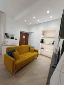 a living room with a yellow couch in a room at A Casa di Nonna Maria in Roccapiemonte
