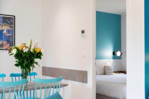 a room with a table and chairs and a bed at La Résidence du Bailli in Rayol-Canadel-sur-Mer