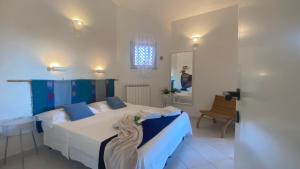 a bedroom with a bed and a table and a mirror at Villa la Bonaccia in La Maddalena