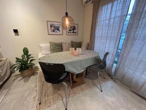 a dining room table with two chairs and a potted plant at Citystugan in Västerås