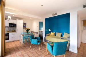 a kitchen and living room with a table and chairs at La Résidence du Bailli in Rayol-Canadel-sur-Mer
