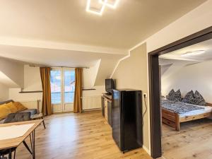 a living room with a refrigerator and a bed at Apartment Frank-2 by Interhome in Feldkirchen in Kärnten