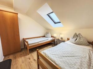a attic bedroom with two beds and a skylight at Apartment Frank-2 by Interhome in Feldkirchen in Kärnten