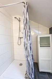 a shower with a black and white shower curtain in a bathroom at Apartment Frank-2 by Interhome in Feldkirchen in Kärnten