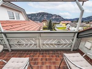 a balcony with chairs and a view of the mountains at Apartment Frank-2 by Interhome in Feldkirchen in Kärnten