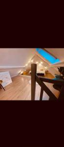 a room with a wooden floor and a table at Le nid du dernier sou in Boulogne-sur-Mer