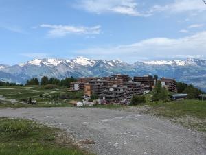 a town on a hill with mountains in the background at Ski-In, ski-out Thyon in Vex