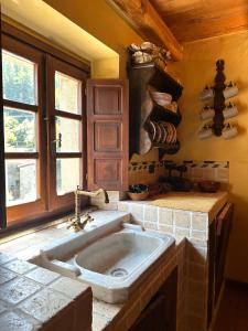 a kitchen with a large sink in a room at Il guardiano del Castello in Fivizzano