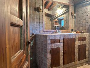 a bathroom with a sink and a mirror at Il guardiano del Castello in Fivizzano +25 photos