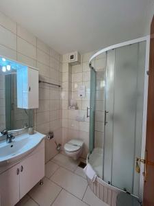 a bathroom with a toilet and a sink and a shower at Dela in Hvar