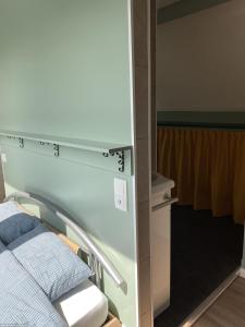 a hospital room with a bed and a mirror at Le Refuge des Châteaux in Chinon