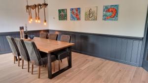 a dining room with a wooden table and chairs at DSW18 Luxury apartment in the centre with beach cabin in Domburg