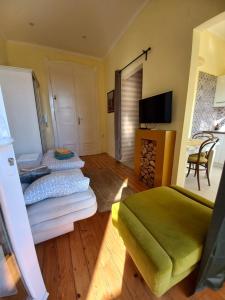 a bedroom with two beds and a flat screen tv at Ergzotic Apartments & Room in Sombor