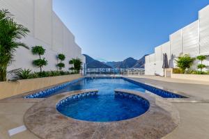 a swimming pool in the middle of a building at Special Rate with Temp Controlled Pool, BBQ & Maid's by Deluxe Holiday Homes in Fujairah