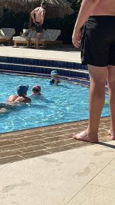 a group of people swimming in a swimming pool at 2 The Green in Tattershall