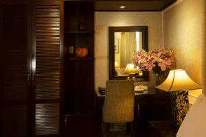 a bedroom with a desk and a mirror and a chair at Anpha Boutique Hotel in Ho Chi Minh City