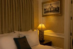 a hotel room with a bed and a lamp at Anpha Boutique Hotel in Ho Chi Minh City